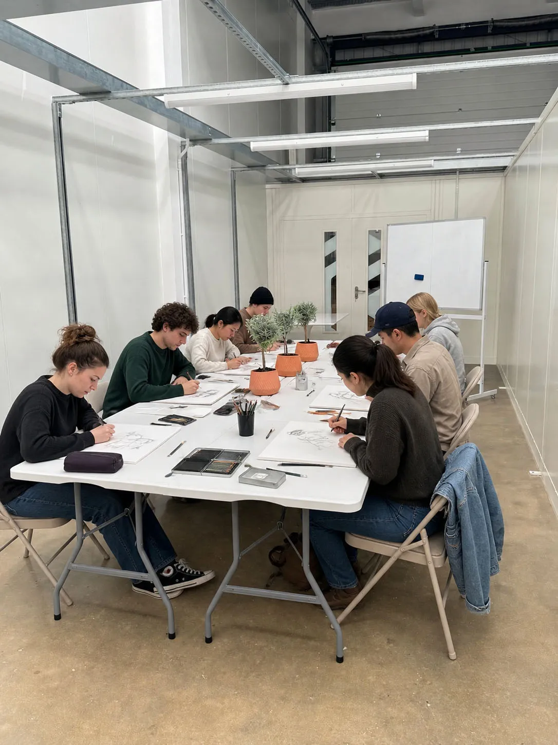 A drawing class in progress at Peterborough Art Studio - sketchpads, pencils and a still-life of olives on the table