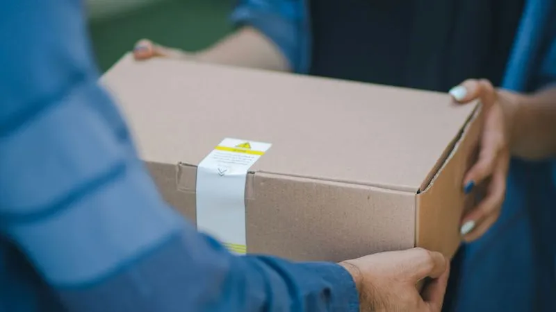 a package being hand delivered to a customer