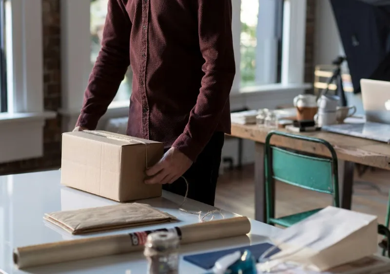 Person adding string around a parcel