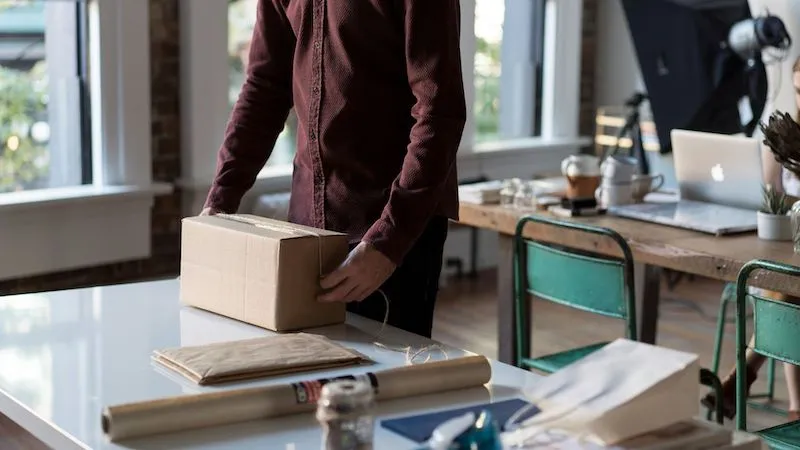 small business owner packing an order ready to send to a customer