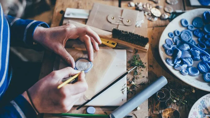 a person crafting some small pottery items