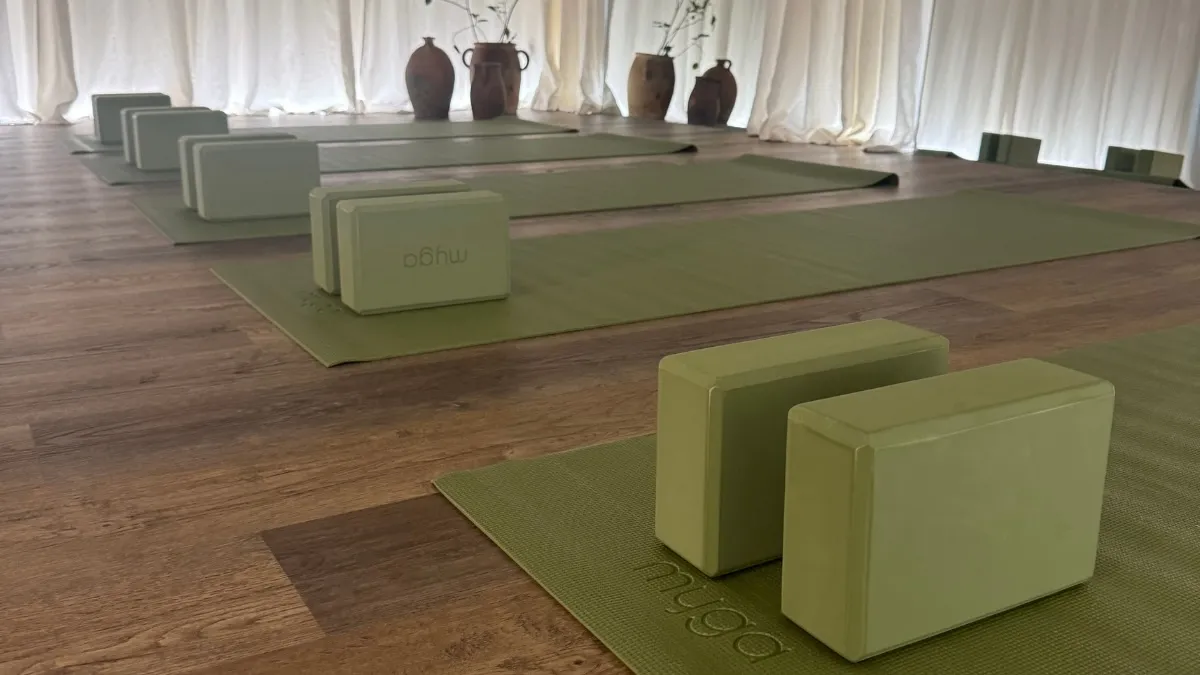 Native Wellness at Native Space — yoga mats and blocks laid out, soft light through linen curtains